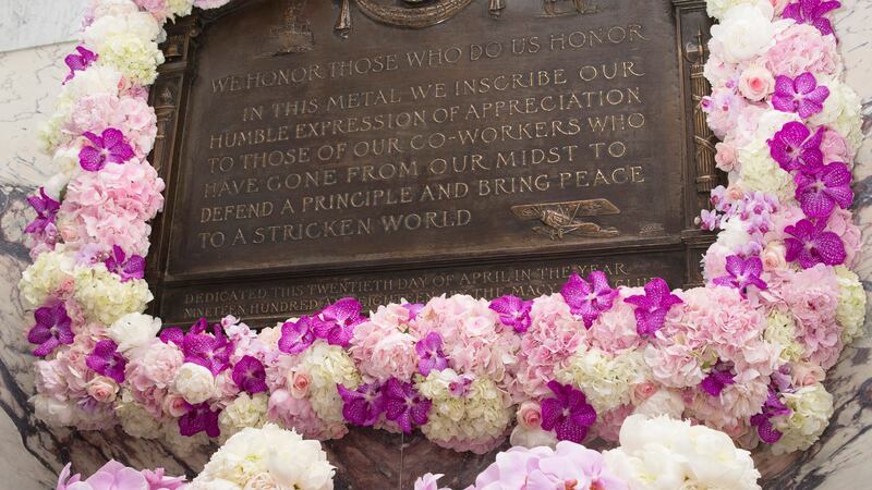 FILE -Flowers adorn the renovated Isidor and Ida Straus memorial plaque as Macy's and the...
