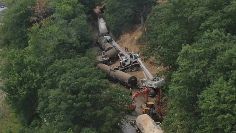 Crews work on cleaning up a train derailment near Penobscot Valley County Club in Orono.