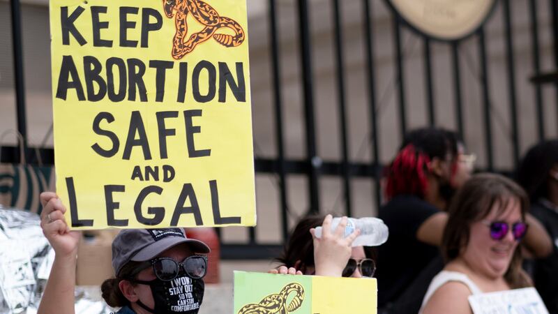 FILE - A small group, including Stephanie Batchelor, left, sits on the steps of the Georgia...