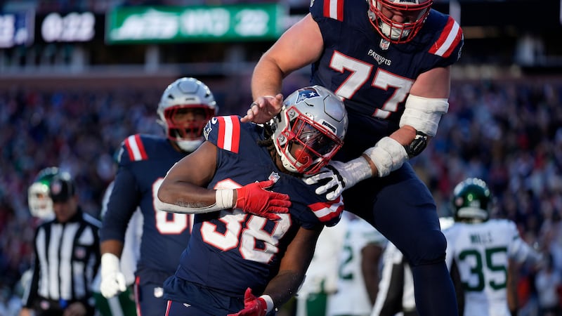 New England Patriots running back Rhamondre Stevenson (38) celebrates after his touchdown with...