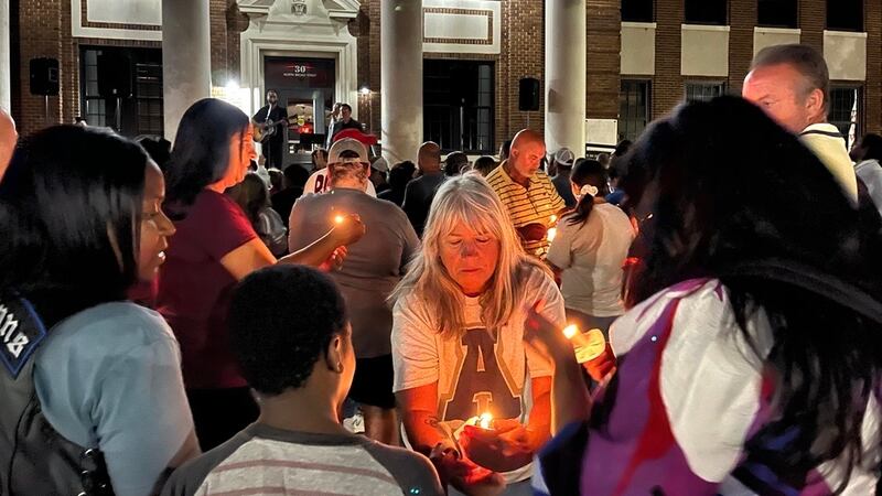 Dozens of people gathered outside the Barrow County Historic Courthouse for a candlelight...