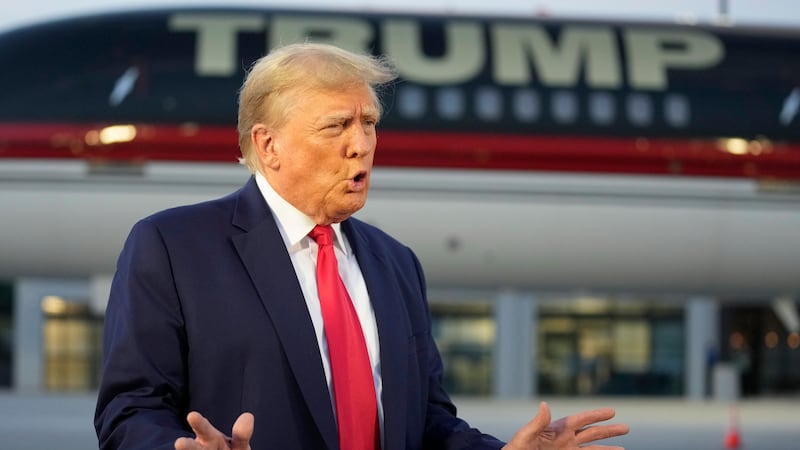 Former President Donald Trump speaks with reporters before departure from Hartsfield-Jackson...