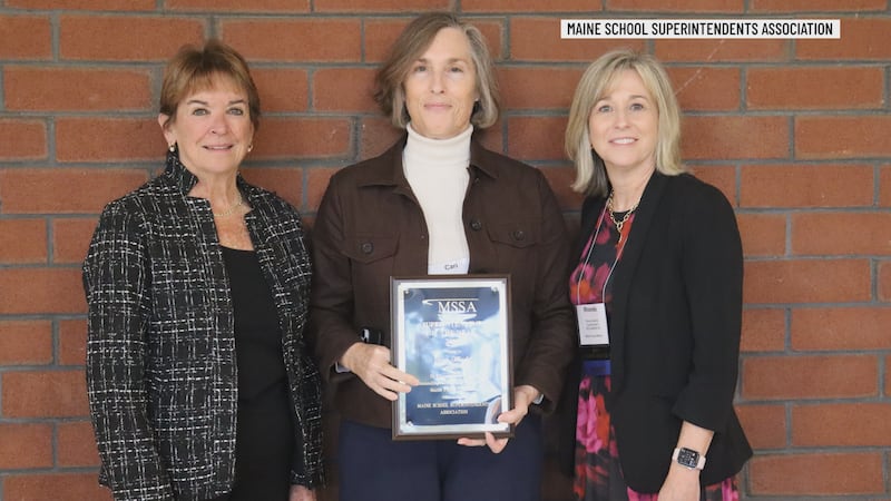 Cari Medd from MSAD 52 holds the 2027 Maine Superintendent of the Year award plaque.