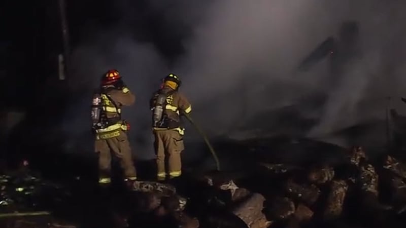 The fire destroyed the single-family home and also spread to the nearby woods.