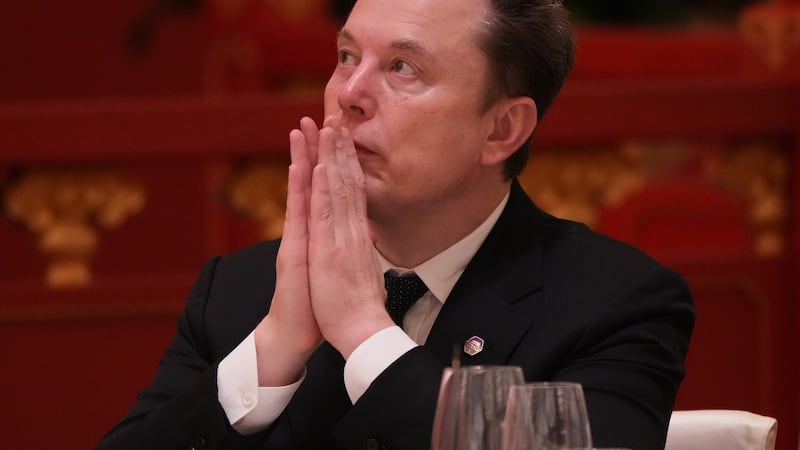 Elon Musk listens to the speech of Chinese President Xi Jinping during a state dinner with...